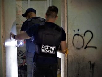 Agents cautiously enter a building during a raid