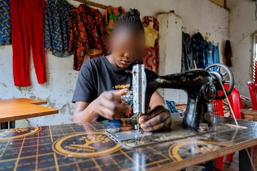 Access to education is widely recognised as the most significant factor in delaying the age of marriage for girls (Image: A trafficking survivor in Uganda receives tailoring training)